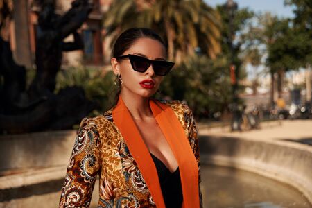 Fashion style closeup outdoor portrait. Young elegant caucasian woman with brunette hair in colorful...
