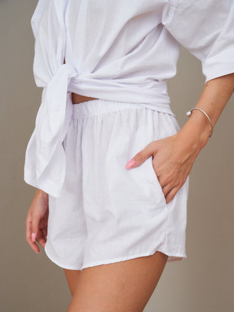 Fashionable young woman showcasing summer style with white outfitの写真素材