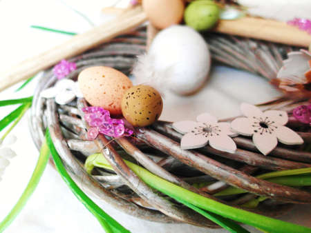 Easter eggs in nest on rustic wooden planks