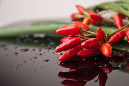 Chili peppers in a copper plate.の写真素材
