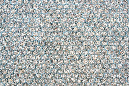 Small stones, pebbles, decorative paving paved the sidewalk in the form of honeycombs. For...