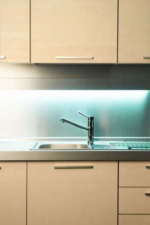Modern stainless steel tap in white kitchenの写真素材