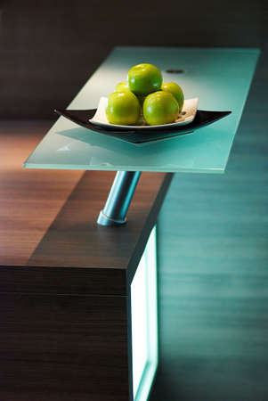 Granny smith apples on table in modern kitchenの写真素材