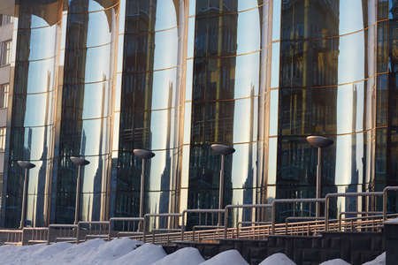 The glass facade of curved blue glassの写真素材