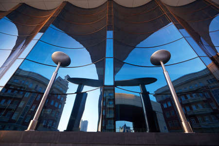 The glass facade of curved blue glassの写真素材