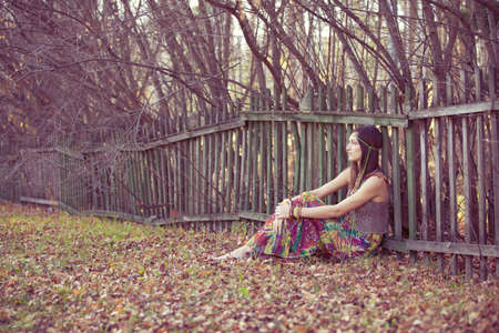 Girl leaned against the fence.の写真素材