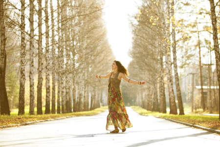 Dancing girl in the rays of the autumn sun.の写真素材