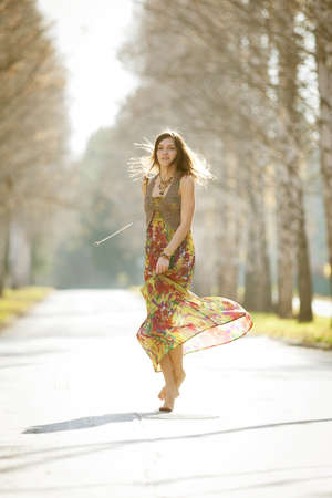 Dancing girl in the rays of the autumn sun.の写真素材