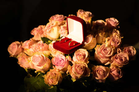 Wedding rings on the yellow roses. Buds. Petals. Bouquetの写真素材