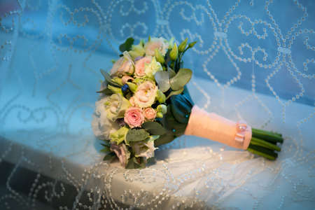Wedding bouquet of the bride on a blue backgroundの写真素材
