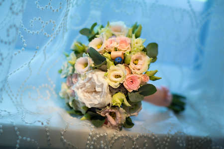 Wedding bouquet of the bride on a blue backgroundの写真素材