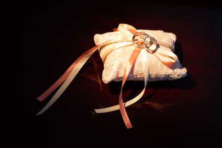 Wedding rings on a pillowの写真素材