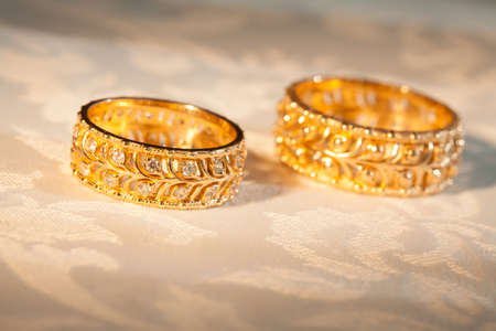 Wedding rings on a yellow backgroundの写真素材