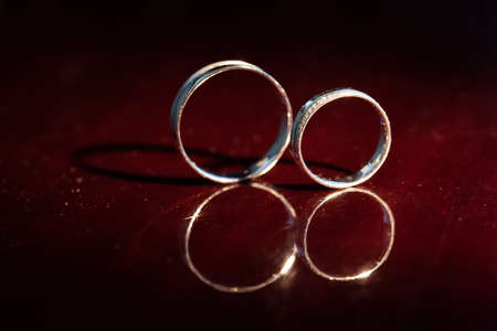 Wedding rings are on a red backgroundの写真素材