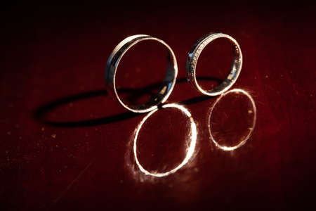 Wedding rings are on a red backgroundの写真素材