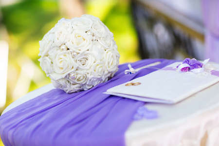 White wedding bouquet and a marriage certificate.の写真素材