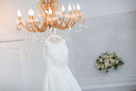 Wedding dress on the chandelier. Morning of the brideの写真素材