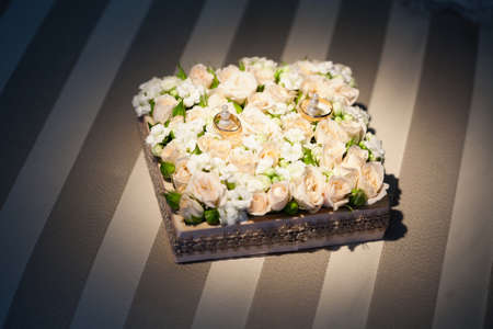 Wedding rings on flower of rose.の写真素材