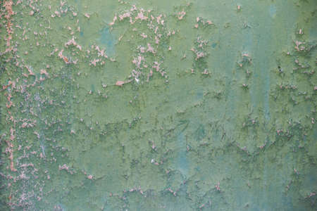 The texture of wall with cracks and green paint.の写真素材