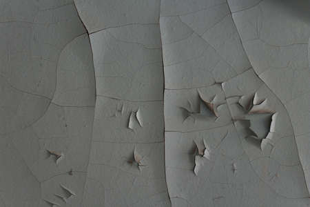 An old gray painted wall in cracksの写真素材