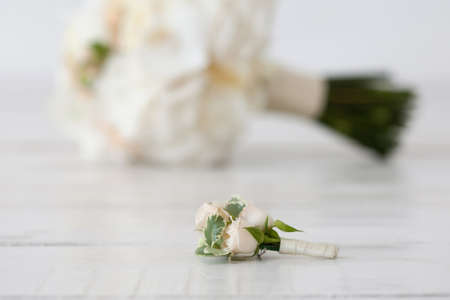 Wedding bouquet of orchids and boutonniere on white background.の写真素材