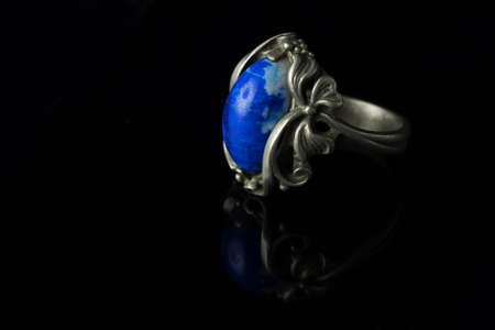 Silver ring with lapis lazuli on a black background.の写真素材