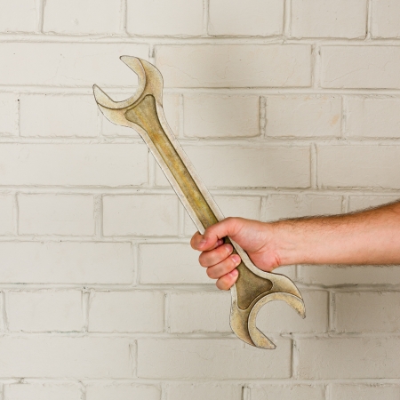 Big spanner in a man hand  Helping handの写真素材