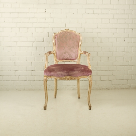 Vintage chair in empty white room with brick wallの写真素材