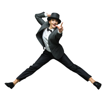 Emotional young woman wearing vintage suit jumping up isolated on white background. Woman pointing at sometrhing amaizing isolated on white background.の写真素材