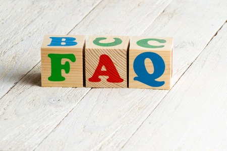 FAQ sign. Colorful wooden blocks on a white wooden backgroundの写真素材