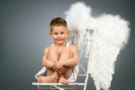 Happy angel kid with white wings