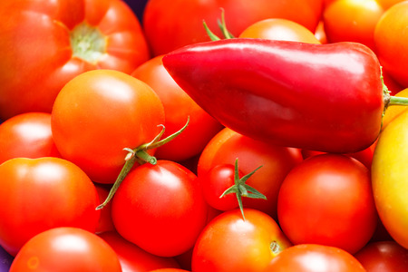 Fresh tomatoes and red pepper backgroundの写真素材