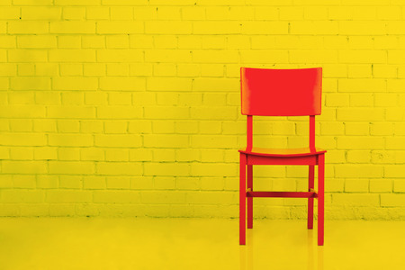Red wooden chair in empty room. Toned imageの写真素材