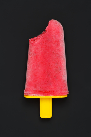 Homemade popsicle with raspberry on a black backgroundの写真素材