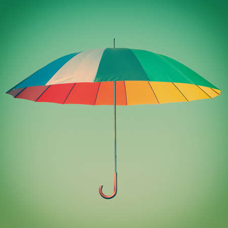 Colorful umbrella against blue の写真素材