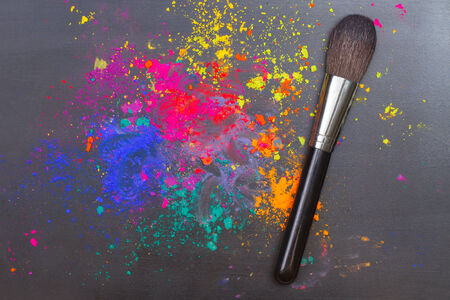 Makeup brush on a background with colorful powder. Beauty conceptの写真素材
