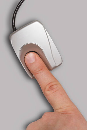 Biometric identification - finger on a fingerprint scannerの写真素材
