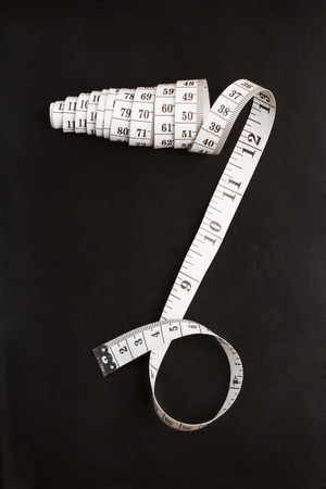 Tailor measuring tape on a chalkboardの写真素材