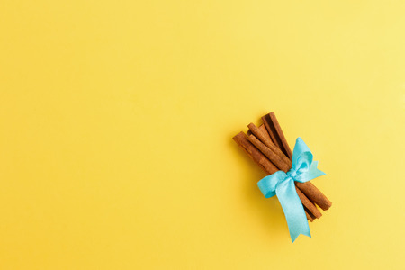 Rolls of cinnamon tied up with ribbonの写真素材