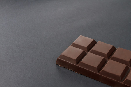 Bar of chocolate on a black background