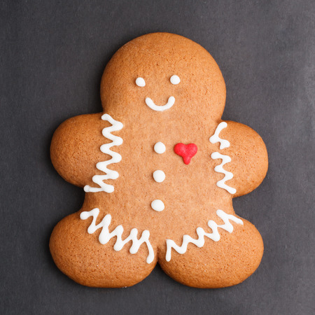 Gingerbread man cookie against black backgroundの写真素材