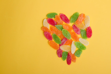 Heart shape made of colorful sweet dried fruit. Valentine background with copyspace