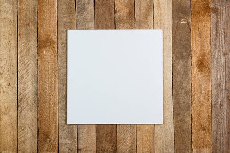 White cardboard on a vintage wooden background