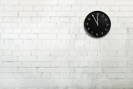 Abstract brick wall with office clock