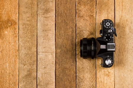 Vintage camera on a wooden background with copy space