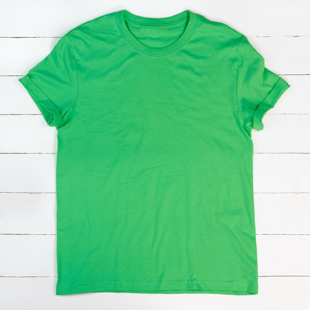 Blank green t-shirt on white wooden backgroundの写真素材