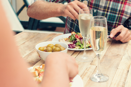 Closeup of couple having dinner together with champagne outdoorsの写真素材