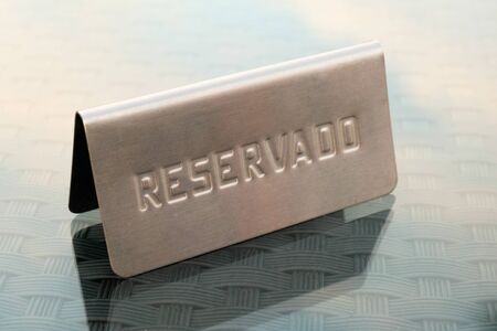 Metal reserved reservado sign on table in restaurant in Spainの写真素材
