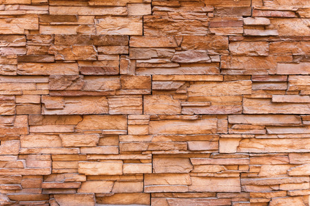 Stone brick wall background or texture. Stone fence outdoors