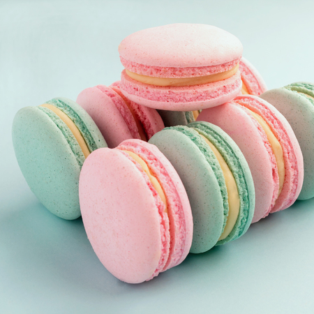 Closeup of colorful mint and strawberry flavor macaroons on blue backgroundのeditorial素材